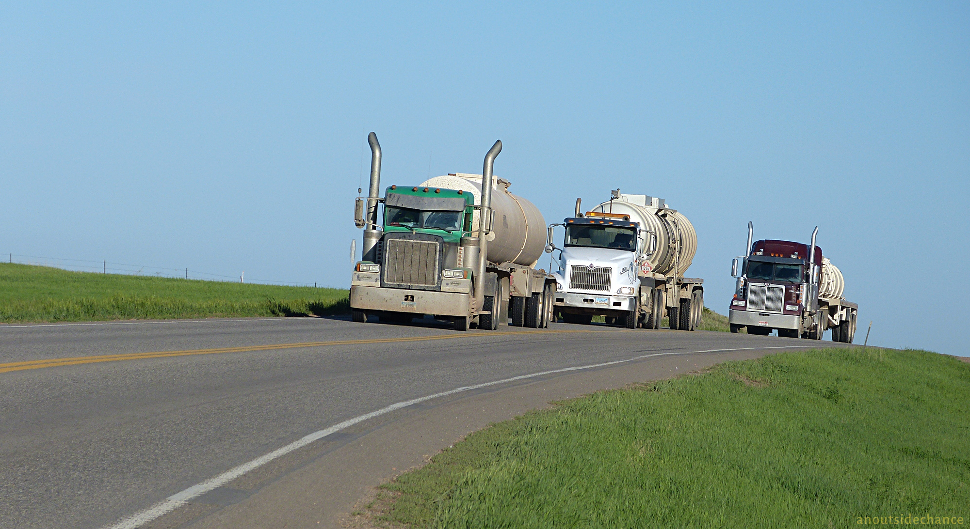 Tractor-trailers hauling oil and water on North Dakota highway.