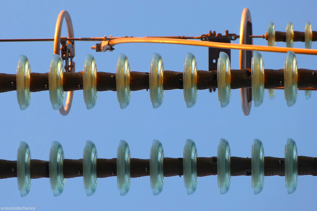 Insulators on high-voltage transmission line.