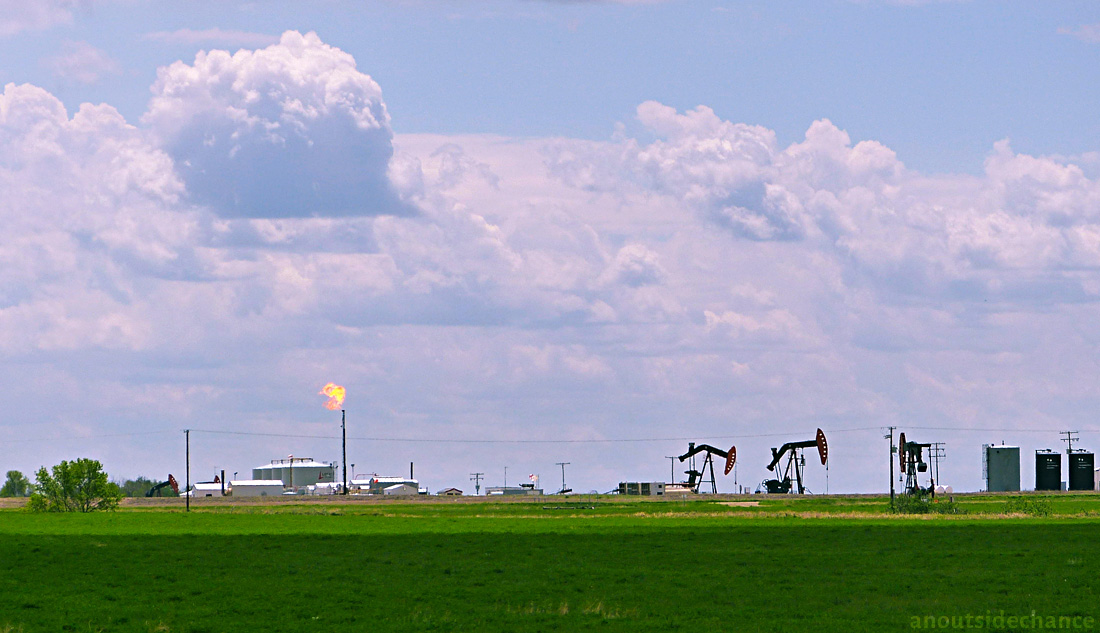 Oil well in southeast Saskatchewan, with flared gas.